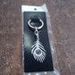 Stainless steel keychain with intricate peacock feather motif