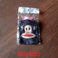 A mini hot water bag with a vibrant emoji cover in active use.