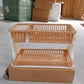 Modern black dish rack with various kitchen utensils draining into a tray.
