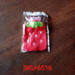 Strawberry print hot water bottle, highlighting its secure cap and durable material.