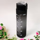 Black motivational water bottle shown with its detachable straw and lid components for easy cleaning.