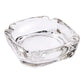 Elegant crystal glass ashtray with four cigar slots on a modern wooden table.