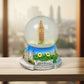 Front view of the decorative snow globe, showcasing its clear dome and base.