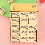 Thirty bright yellow 4B erasers neatly packaged for students and office use.