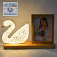 Duck-shaped crystal LED lamp glowing softly with photo frame