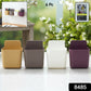 Four mixed-colour Wall Mounted Mobile Holders on a smooth, clean wall surface.