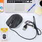 Black Compshop Wired Optical Mouse M-022 with USB cable on a desk.