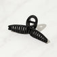 Person styling hair effortlessly with a strong, non-slip hair claw clip