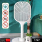 Hand holding the electric fly swatter, ready to zap insects.