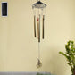 Dragonfly outdoor wind chime with vibrant colours in garden setting