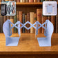 Adjustable book organizer stand expanded on a desk holding books