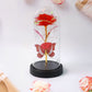 Crystal-clear plastic dome enclosing LED eternal rose with butterfly accent