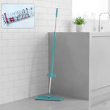 Flat floor cleaning mop with long handle and rectangular mop head on floor