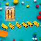 Overhead view of various colorful engineering construction vehicle toys on a white surface.