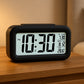 Digital LCD alarm clock with backlight showing time and temperature
