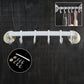 Wall-mounted bath towel hanger securely holding clean towels in a modern bathroom.