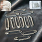Single decorative silver safety pin brooch featuring sparkling crystal detail