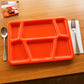Red plastic multi-compartment rectangular meal serving tray with six sections