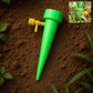Plant Watering Spike gently watering potted plants in garden