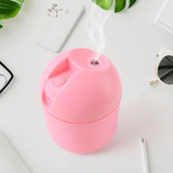 USB Mini Air Humidifier on desk emitting cool mist with soft LED light
