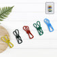 Metal clothes clips holding clothes on an outdoor line during windy weather