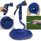 Expandable garden hose fully extended with spray gun, ready for use.