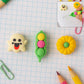 Collection of cute cartoon erasers in various 3D shapes like ghost, pea pod, and pumpkin.