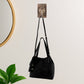 Clear self-adhesive wall hook for compact storage
