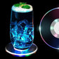 Round LED cocktail coaster switched on, displaying festive colorful lights.