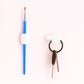 White multifunctional hand-shaped wall clip organizing various small items