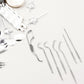 The compact AuriGlam 7-in-1 dental hygiene kit with all tools visible.
