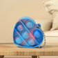 Several mini fidget keychains in various shapes and colors, demonstrating their compact size and portability.