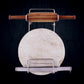 Elegant stainless steel stand securely holding a wooden rolling pin on a kitchen counter.