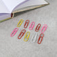 Mixed colour steel paper clips with protective vinyl coating to prevent paper damage and rust.