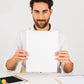 A4 copier paper stack on wooden desk with office supplies
