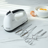 Electric hand mixer set with stainless steel beaters and dough hooks on countertop
