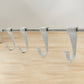 Side view of the sleek stainless steel kitchen utensil hanger with its six sliding hooks.