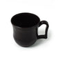 Durable black plastic coffee mug with a sturdy handle, ready for your morning chai.