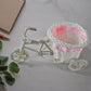 Side view of bicycle flower pot stand holding flowers