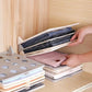 Wardrobe drawer with multiple Clothes Folding Boards neatly stacked, showcasing organized garments.