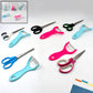 Stainless steel kitchen scissor and vegetable peeler set on a clean surface.