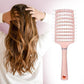Massage hair comb placed on wooden surface highlighting ergonomic grip