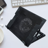 Sleek black laptop cooling pad with fan and adjustable stand, ready for use.