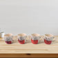Top view of ceramic cups and glass bowls in 9-piece set