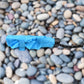 The DrizzlePro 3-fold umbrella neatly packed in its protective sleeve, ready for compact storage.