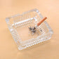 Top-down view of the glass ashtray, showing the four integrated slots for cigarettes.