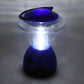 Person holding the compact Indo Glow Mini Camping Lantern, showcasing its portable design.