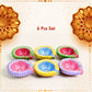 Assortment of colorful hand-painted clay diyas in a gift box, ideal for Diwali gifting.