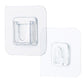 Single clear adhesive hook securely mounted on a smooth wall surface.