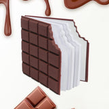 Closed chocolate scented diary with a bite-shape design on a white background.